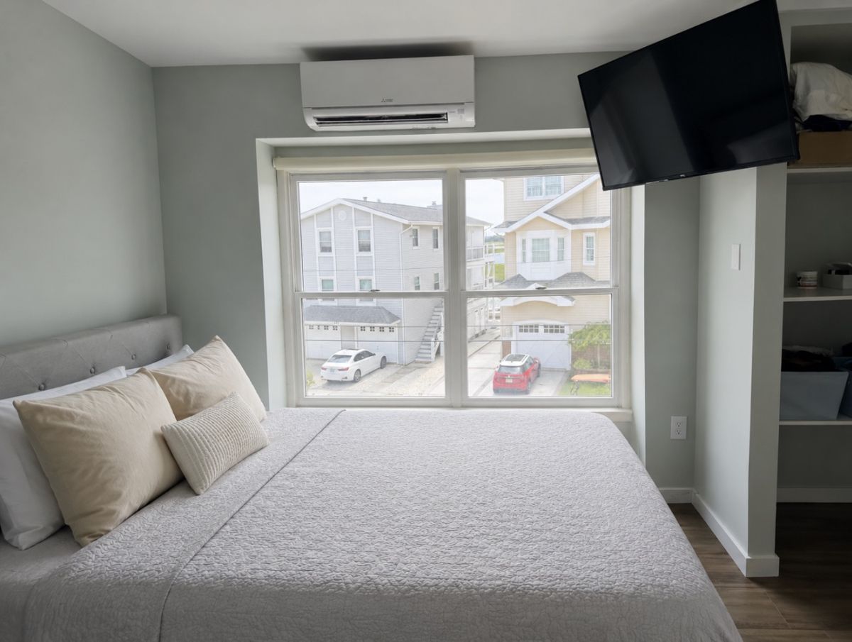 Bedroom with crisp made bed ready for guest check-in