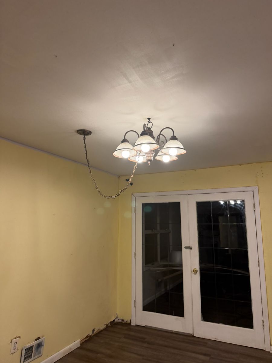 Same chandelier with clean ceiling and gleaming room after deep cleaning