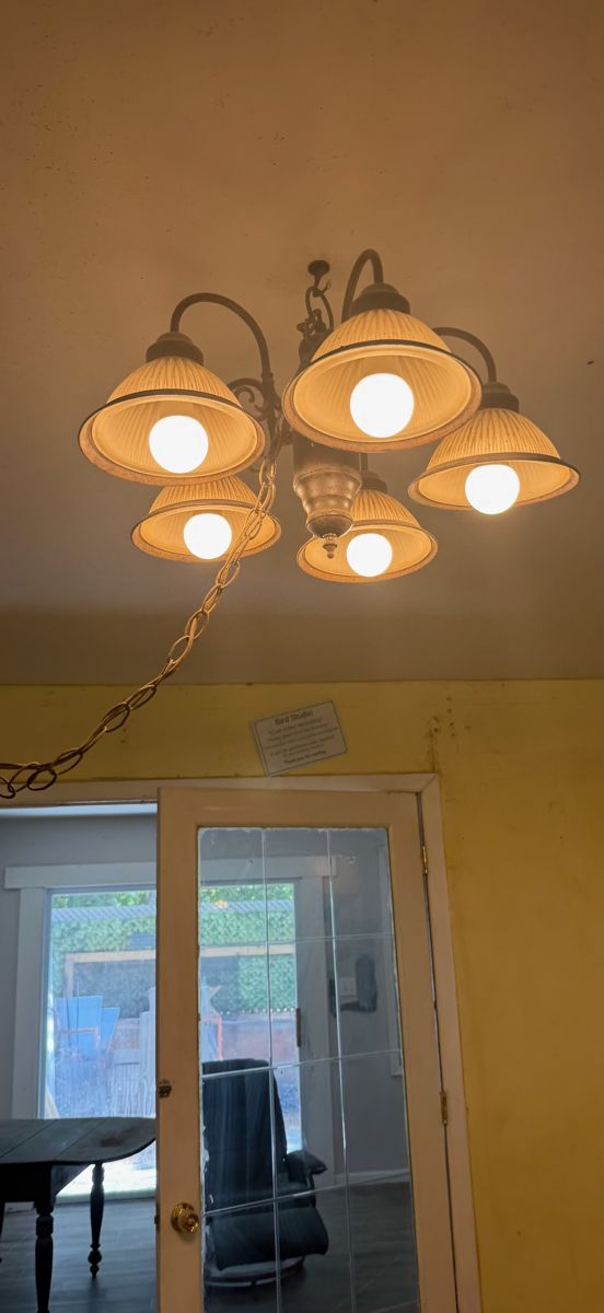 Chandelier with dingy ceiling and walls before deep cleaning