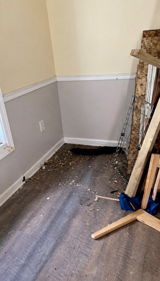 Room corner filled with lumber and debris before junk removal and deep cleaning