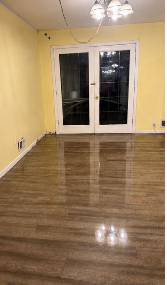 Same dining room with mirror-shine floors after deep cleaning