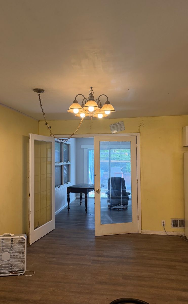 Dining room with dull floors and scuffed walls before deep cleaning