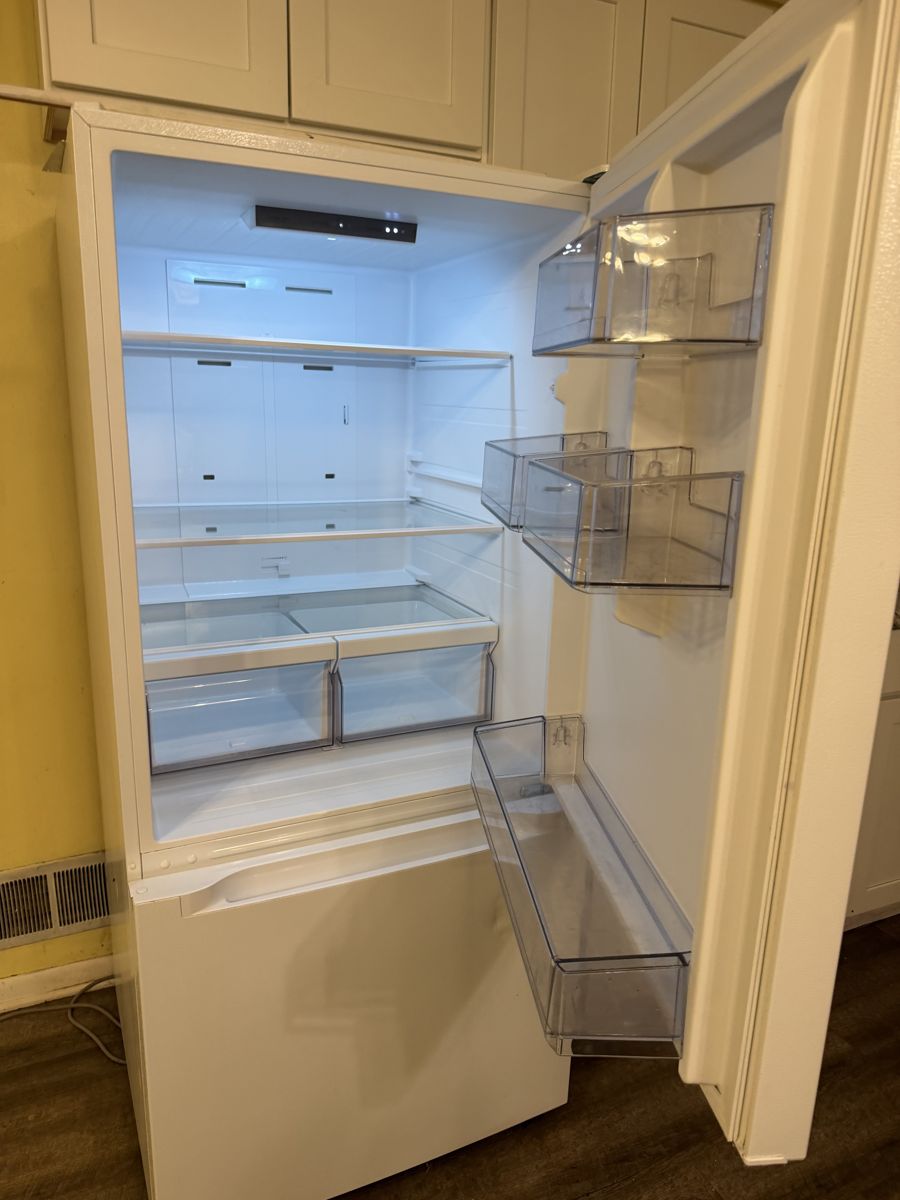 Fridge interior emptied and spotless after cleaning