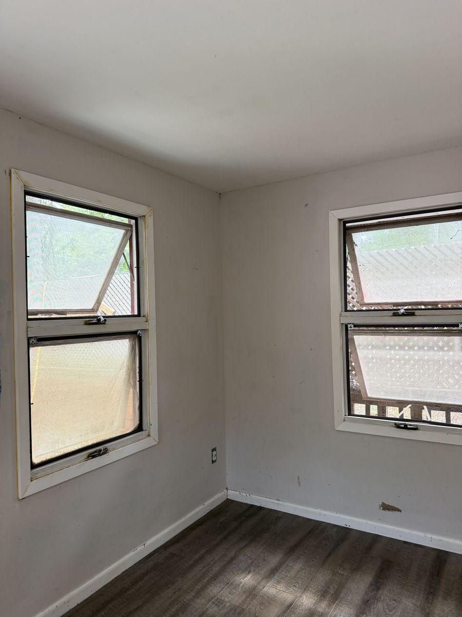 Laundry room window corner with clean bright walls after deep cleaning