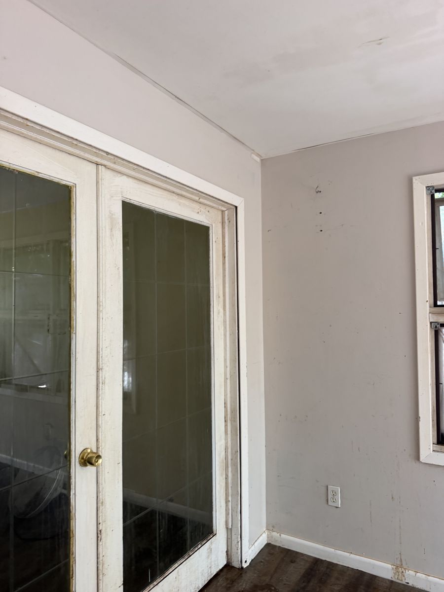 Laundry room french doors with grime and scuffed trim before deep cleaning
