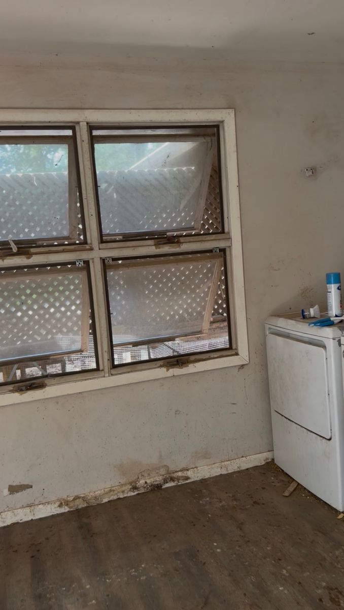 Washer wall with grimy window sill and floor before deep cleaning