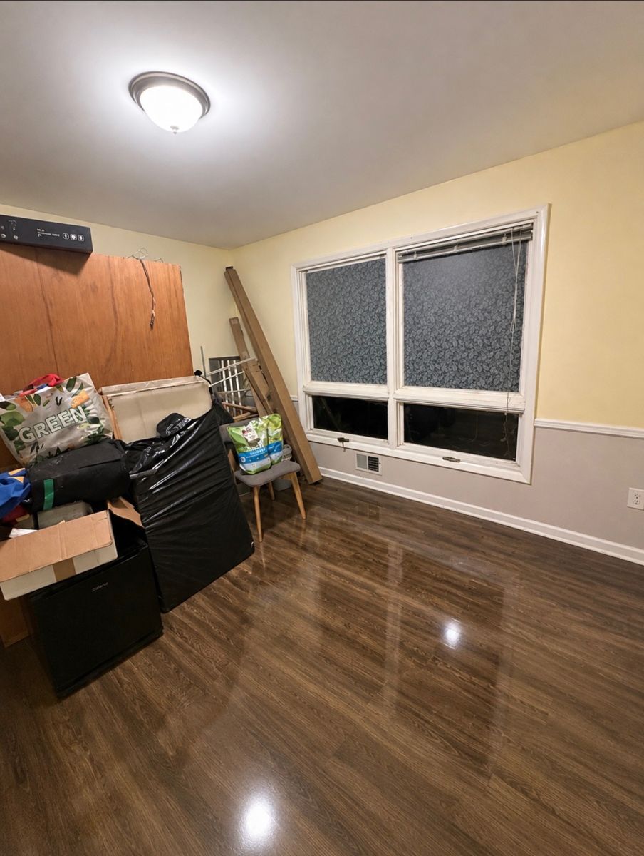 Bedroom packed with clutter and boxes before a move-out deep clean