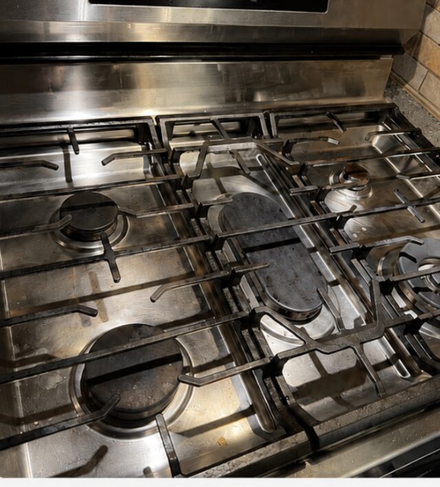Gas stove covered in grease and buildup before deep cleaning